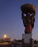 Statue at the western entrance to Souk Lahad depicting a local woman in traditional garb (here, seen from behind).