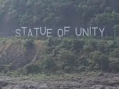 Statue of Unity sign board across the river