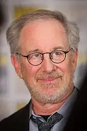 A man with glasses and gray hair in professional attire.