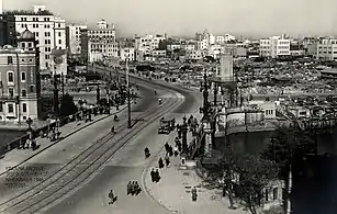 A large Japanese city with American soldiers patrolling the streets