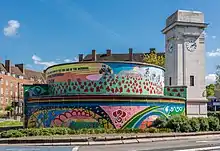 Round air-raid shelter, with a colourful mural