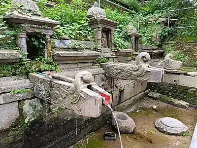 Stone water fountain behind Bajrayogini temple