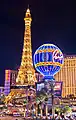 The Eiffel Tower and balloon sign at night