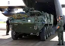 The M1129 being unloaded from a C-130 Hercules aircraft.