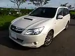 Subaru Exiga tS, a high-performance variant of the standard Subaru Exiga minivan. This photo shows the front of the car, which is white with a small "tS" emblem on the front grille, which stands for "tuned by Subaru".