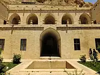 View of the main courtyard, looking north to the central iwan and the terrace of the upper floor