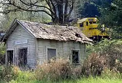 A train passing by Summit's former post office