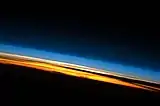 Limb view, of Earth's atmosphere. Colors roughly denote the layers of the atmosphere.