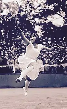 Lenglen hitting her signature leaping volley shot at the net