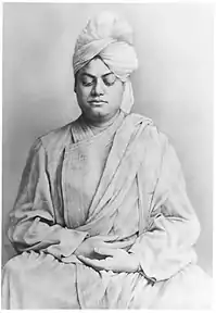 Formal photograph of Swami Vivekananda, eyes downcast