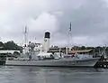 HSwMS Spica moored outside of the Vasa Museum in July 2005. The tall funnel belongs to SS Sankt Erik, moored on the other side of the jetty.