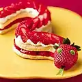 A strawberry cake prepared in the shape of a snake