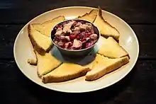 A plate of traditional Kadazan swordfish hinava served with sandwich breads as an appetizer.