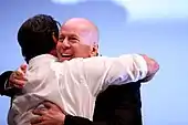 Bruce Willis hugging fellow actor Sylvester Stallone