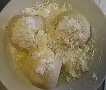 three dumplings sprinkled with sugar and butter in a bowl