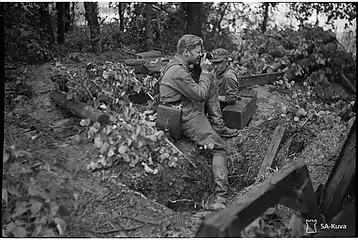 A TK man photographing at the frontline.