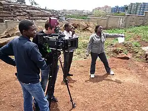 Image 6Filmmaker Nathan Collett (with camera) shooting feature film Togetherness Supreme in collaboration with Kibera youth trainees. (from Culture of Kenya)