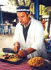 Image 16A man makes plov, the national dish of Tajikistan. (from Culture of Tajikistan)