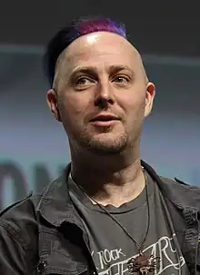 Taliesin Jaffe with a purple-pink mohawk shown smiling