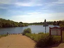 Forge Mill Lake. The RSPB reserve's bird hide is visible across the lake, in the centre of the photograph.