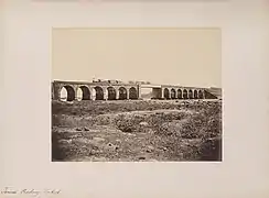 Train on a stone bridge with girder