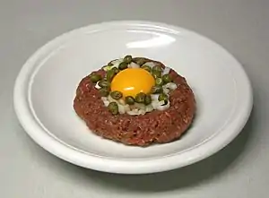 Steak tartare is a meat dish made from finely chopped or minced raw beef, venison, or horse meat.