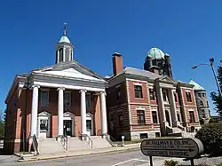 The building to the left is now used as a performing arts center called "The District Center for the Arts"