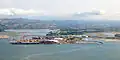 Essentially all the land except the foreshore in this view of Tauranga is volcanic and most is contributed to by the Tauranga Volcanic Centre with its high hills at either side except at centre where Mamaku ignimbrite from the Rotorua Caldera has flowed from the horizon down to the waters edge.