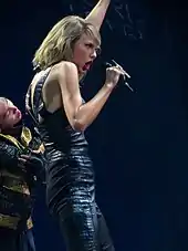 Taylor Swift on the 1989 Tour, donning a black leather suit