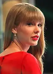 Taylor Swift wearing red lipstick and a red dress