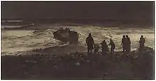 Dark photograph showing a group of people on the coast, looking out to a sinking boat