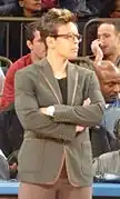 Jeff Walz, coach of the Louisville Cardinals women's basketball team and winner of the 2008 Maggie Dixon Award, standing on the sideline at a UConn vs Louisville game in Veterans Memorial Coliseum