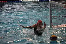 woman lunging across the water