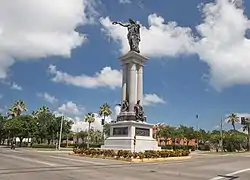 Henry Rosenberg contributed this statue to the citizens of Galveston. It was a memorial to the heroes of the Texas Revolution. A dedication ceremony was held on San Jacinto Day, April 21, 1900, and featured a parade and ceremonies attended by Governor Joseph D. Sayers. The monument was created by Italian-American sculptor Louis Amateis. It is made of bronze and granite and features the female form of Victory holding a laurel wreath in an outstretched arm pointing to the San Jacinto Battleground across the bay, where Sam Houston defeated Santa Anna, winning independence for the Republic of Texas.