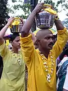 Devotees carry 'paal kudam' offerings at Thaipusam festival