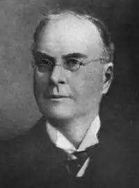 A black and white photographic portrait of Thayer Melvin in his later years.