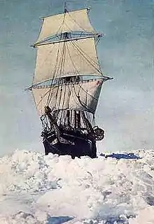  Frontal view of ship with sails all set, moving through thick sea ice