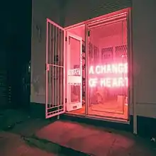 The artwork for A Change of Heart showing a neon sign spelling out the song's title