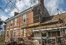 Old brick house with scaffolding in front