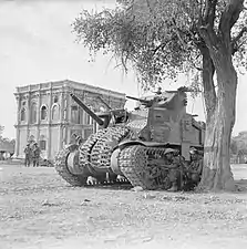 Indian troops take cover behind Lee tank during street fighting in Mandalay