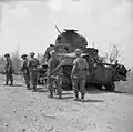 Men of the 2nd Dorsetshires passing a knocked out Lee tank at Mount Popa, April 1945