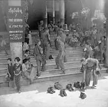 Image 20British soldiers remove their shoes at the entrance of Shwedagon Pagoda. To the left, a sign reads "Foot wearing is strictly prohibited" in Burmese, English, Tamil, and Urdu. (from Culture of Myanmar)