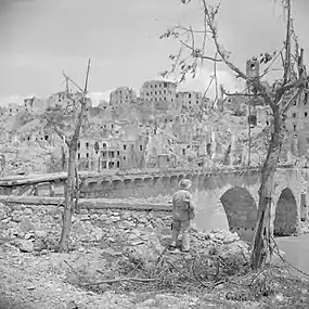 A soldier looking a the ruined city of Pontecorvo