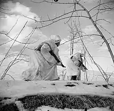 Indian troops proceed through snow near Castel Bolognese