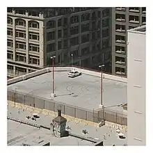 The album cover depicts a single car on a rooftop.