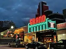 The neon lights of The Grand's marquee light up Main St. in downtown Ellsworth, Maine at dusk.