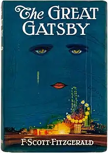 Dust jacket of The Great Gatsby by illustrator Francis Cugat. The book cover has a white-lettered title against a dark blue sky. Beneath the title are lips and two eyes, looming over a carnival-like metropolis.