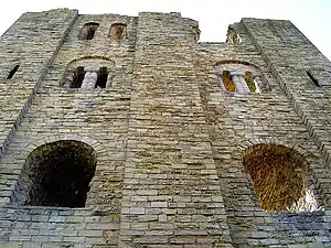 Limestone ashlar masonry in even courses at Scarborough Castle. The buttresses of low profile are characteristic of Romanesque building.