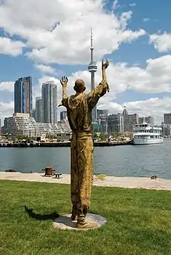 Migrants (bronze), 2007, Ireland Park, Toronto Harbourfront. The Jubilant Man stands 320 cm tall.