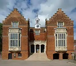 Red-brick Tudor-style building with castellated gables